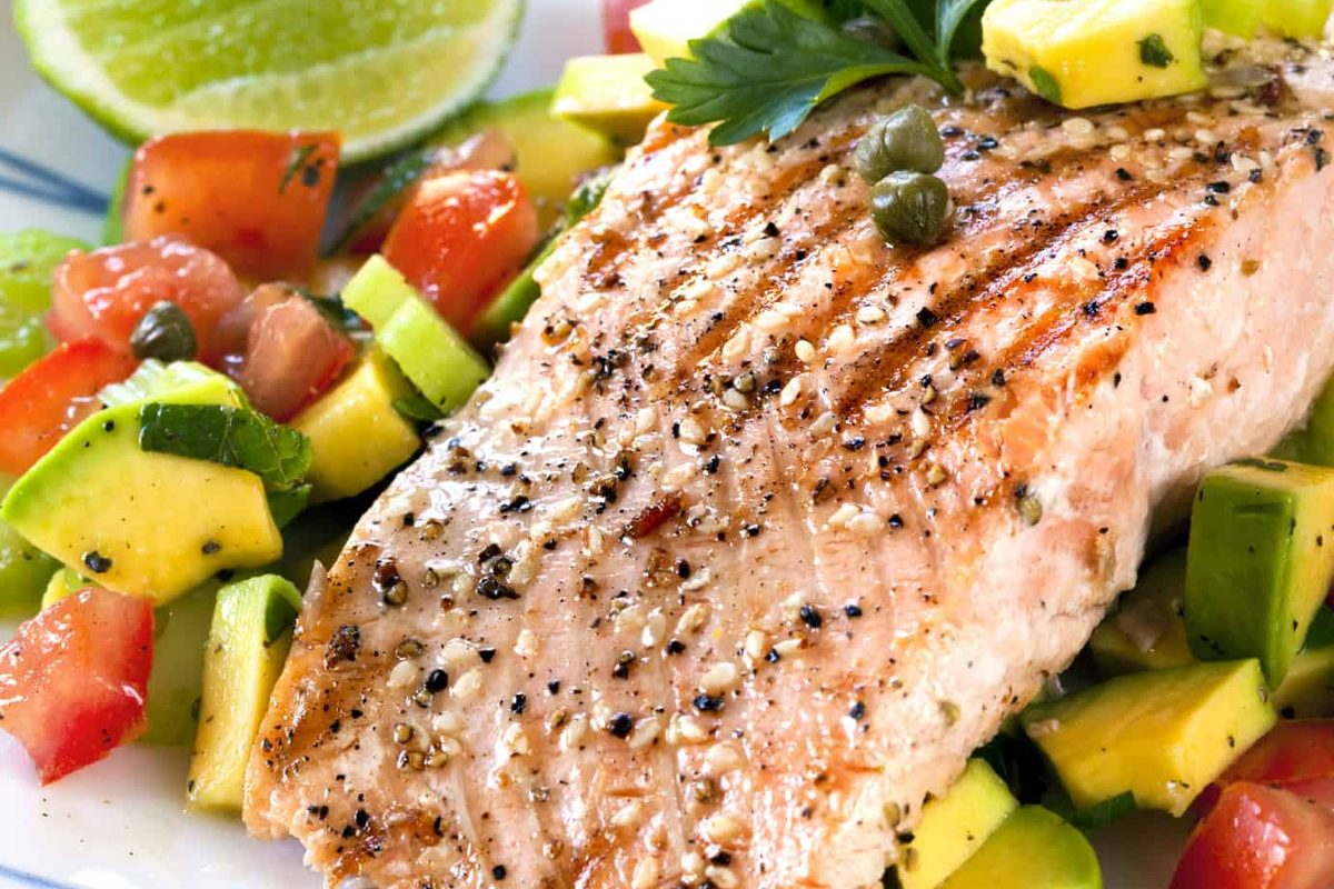 Pan-seared salmon with avocado and mango salsa, plated for a Gourmet Crepes catered dinner